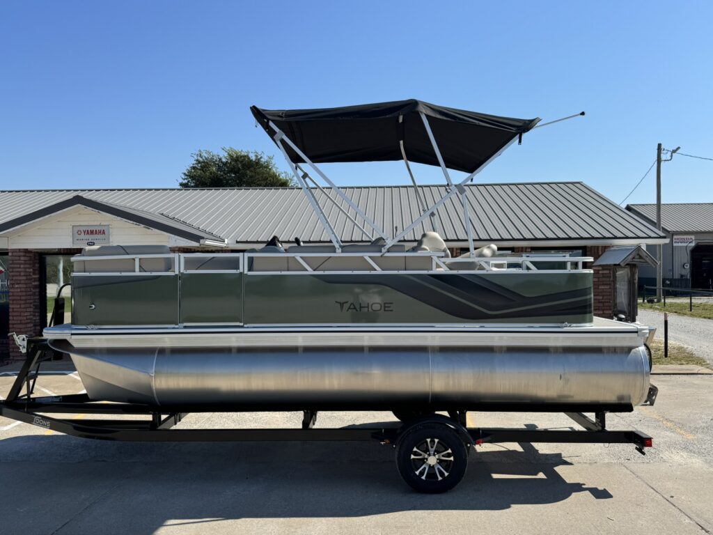 A 17 foot pontoon from Tahoe boats for easy riding on Grand Lake, sitting in front of the Toons Grand Lake location