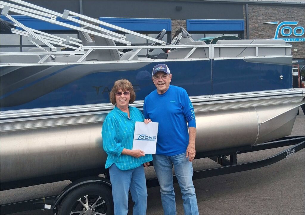 Happy customers of Toons Eufaula standing in front of their brand new Tahoe Sport 1780
